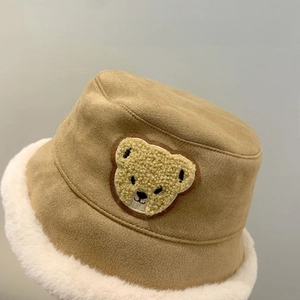 Close-up of khaki winter bucket hat featuring plush fleece lining and cute bear embroidery