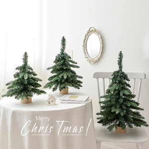 Set of three mini green Nordic Christmas trees with wooden bases for table decoration