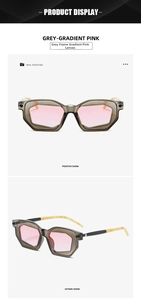Detail view of irregular geometric sunglasses with grey frames and pink gradient lenses