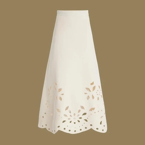 Detailed view of white high-waist maxi skirt featuring delicate laser-cut floral patterns