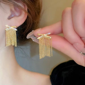 Elegant gold bow earrings with zircon pavé and long chain tassels for women