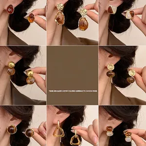 Irregular resin stud earrings in amber brown tones with 18K gold plated silver pins