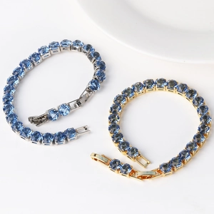 Close-up of 6mm round blue zircon tennis bracelets in silver and gold plating