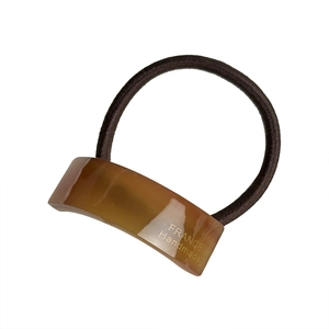 Minimalist brown acetate hair tie with golden lettering on a high-elastic ponytail band
