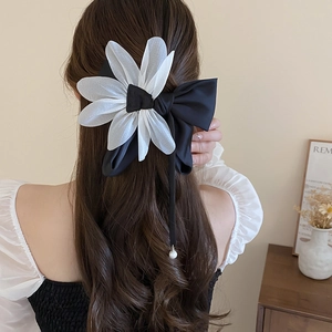 Elegant large fabric bow hair clip with organza petals and pearl ribbon on long hair