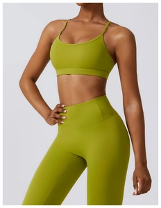Close-up of avocado green yoga set featuring thin straps and high-waist leggings details