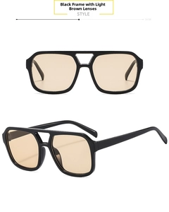 Detail view of square pilot sunglasses featuring a black frame and light tawny lenses