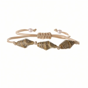 Detail of bohemian shell bracelet with adjustable beige cord and natural conch elements