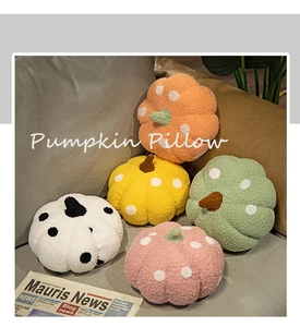 Plush pumpkin pillows in assorted colors arranged on a cozy grey sofa for home decor