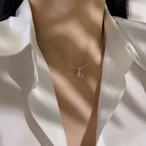 Close-up of 18k gold plated necklace with hollow square pendant on model's neck
