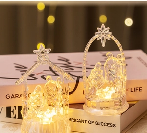 Detailed view of warm LED glowing crystal-like nativity scene ornaments on a book