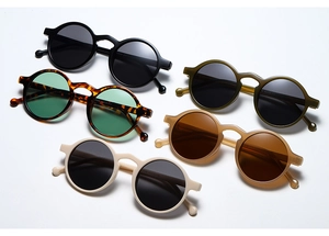 Multiple colors of retro round frame sunglasses displayed on a clean white background
