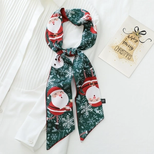 Detail of Christmas themed narrow silk scarf with Santa Claus pattern on white shirt