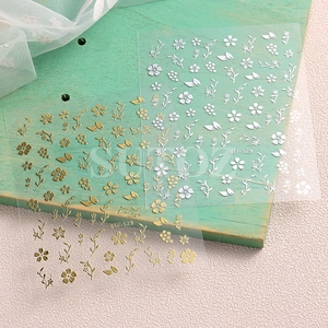 Macro shot of gold and silver cherry blossom nail art stickers with model code BTF-S29