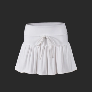 Detailed view of white pleated tennis skirt showing drawstring waist and knit fabric texture