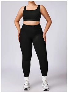 Detail view of black plus size yoga set with U-neck sports bra and high-waist leggings