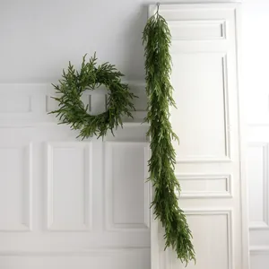 Artificial evergreen Christmas garland and wreath set with realistic green cedar texture