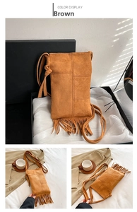 Detailed view of brown suede crossbody bag with decorative fringe and cross stitching