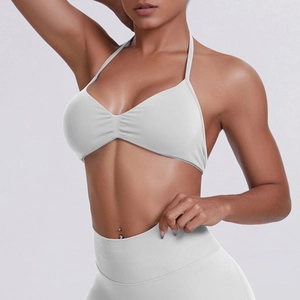 Detailed side view of white ribbed seamless halter sports bra and high-waisted yoga pants