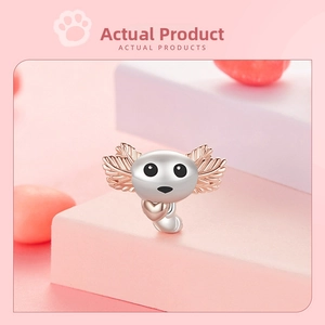 Macro view of S925 silver axolotl charm with rose gold gills holding a small heart