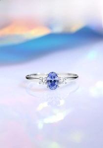 Detailed close-up of a 925 silver ring featuring an oval blue stone and side diamonds