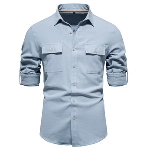 Macro detail of cotton shirt collar with size M label and buttoned chest pockets