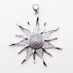 Macro detail of sunburst pendant with micro-pave zircons and 18K gold plating