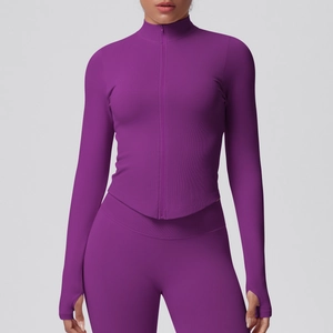 Detail of purple ribbed yoga jacket featuring stand collar, zipper, and thumbholes