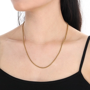 Close-up of a minimalist golden stainless steel pearl chain necklace worn by a model