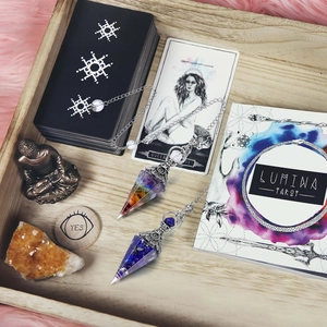 Chakra resin crystal pendulum with Lapis Lazuli and hexagonal cone on a tarot wooden tray