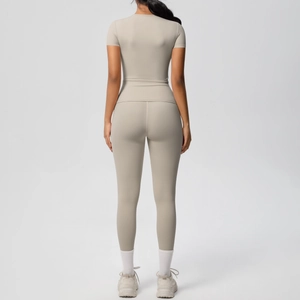 Back view of beige two-piece fitness set with breathable short sleeve top and leggings