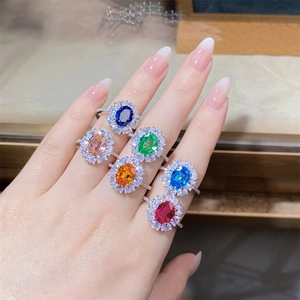 Macro detail of oval cut gemstones with sparkling halo setting in silver ring for women