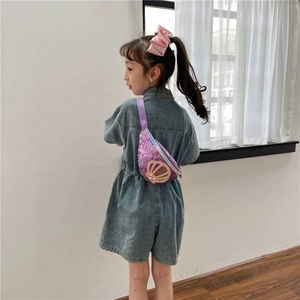 Purple sequined shell-shaped crossbody bag for girls shown on a young model outdoors