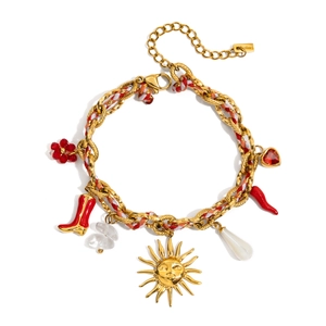 Detail of colorful woven rope bracelet with gold charms including sun and red chili