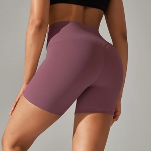 Rear view detail of high-waisted mauve yoga shorts featuring peach lift stitching