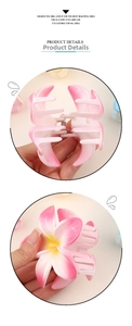 Detail view showing pink gradient plumeria hair claw clip with sturdy metal spring