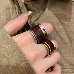 Close-up of dual-layer enamel rings with wide bands and polished metallic edges