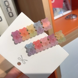 Close-up of cute gradient gummy bear hair clips on a white display card pack
