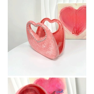 Pink marble acrylic handbag with heart-shaped handle and rhinestone studded edges