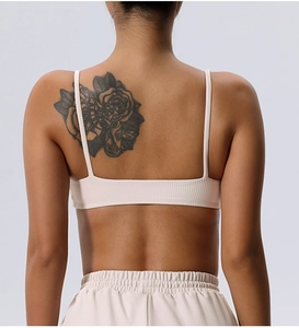 Close-up of cream white ribbed sports bra back featuring thin straps and elastic fabric