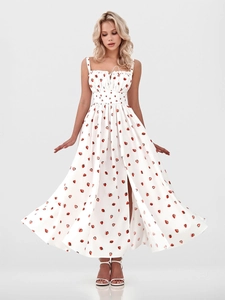 Detail of white floral sundress with red strawberry print and front slit design