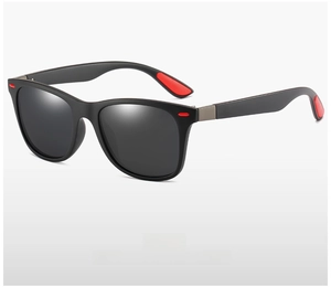 Macro view of polarized lenses and matte black frame with red detail on temple