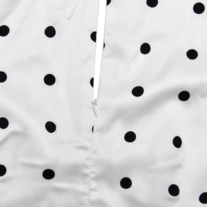 Close-up of invisible zipper on white fabric with black polka dots for dress