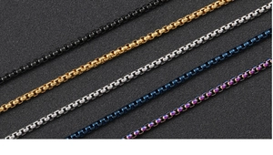 Detail of square box chains in black, gold, silver, blue and rainbow stainless steel