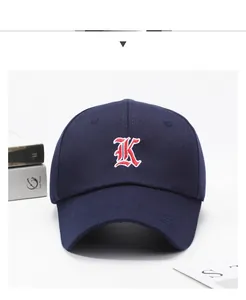Detail of dark blue baseball cap featuring high-quality gothic K embroidery on cotton fabric