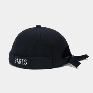 Detail of black docker hat with white PARIS embroidery and adjustable back strap