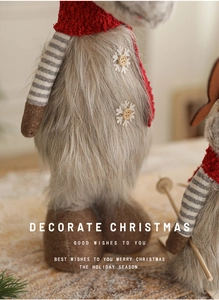 Detailed close-up of plush Christmas reindeer with red scarf and snowflake button decor