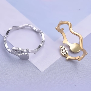Close-up of adjustable leaf design rings in gold and silver stainless steel finishes