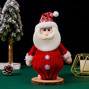 Knitted Santa Claus doll figurine with snowflake decor on a rustic wooden base