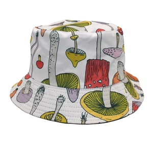 Close-up of colorful mushroom print and fine stitching on white cotton bucket hat